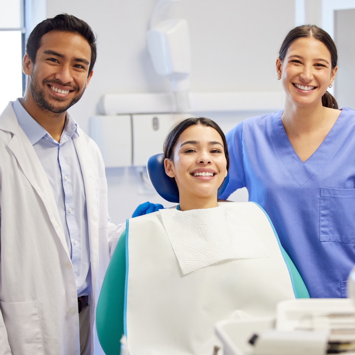 A happy dentist, patient, and nurse